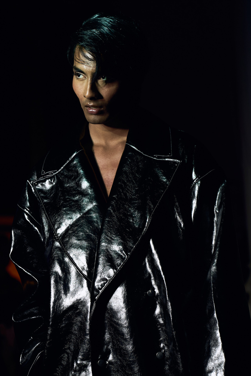 Fashion portrait, model wearing black vinyl trench coat, dramatic chiaroscuro lighting