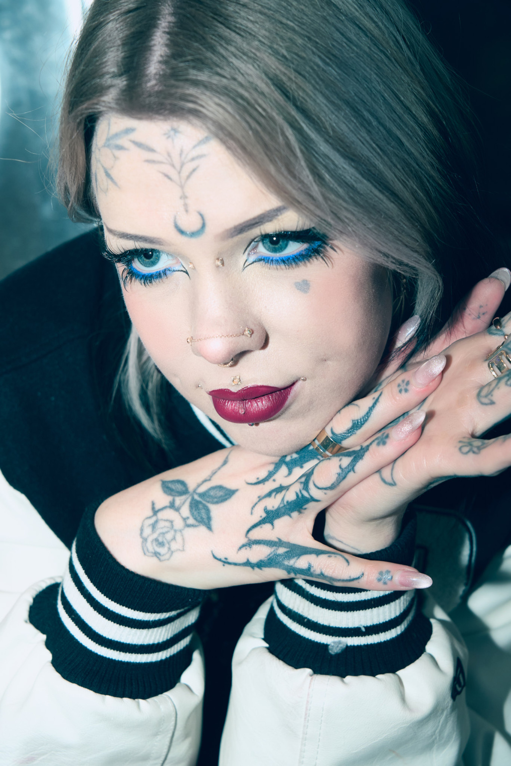 Editorial portrait, model in launderette setting, harsh flash lighting
