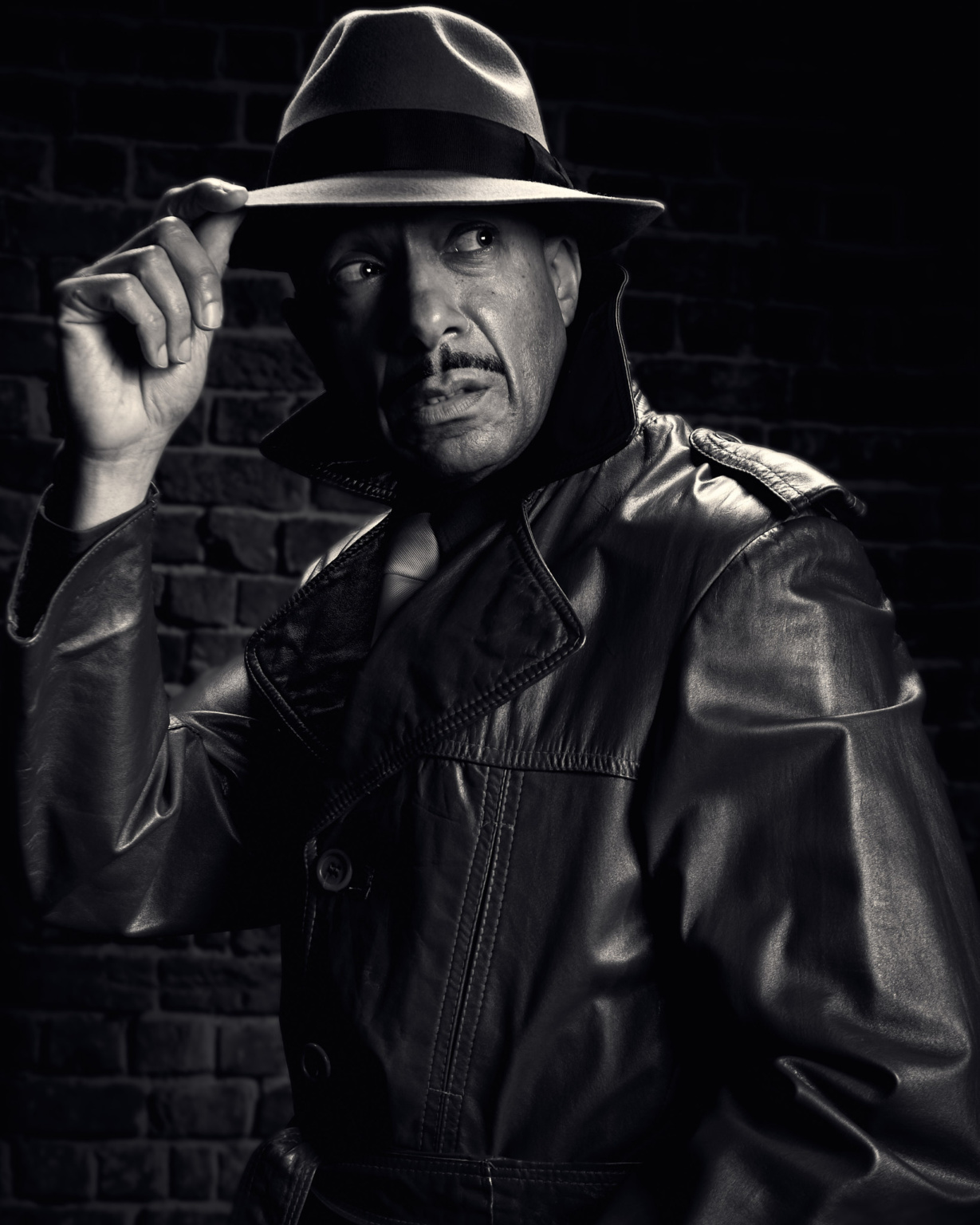Fashion noir portrait, Sin City inspired, model wearing hat, a leather trench coat and a tie, dramatic noir lighting
